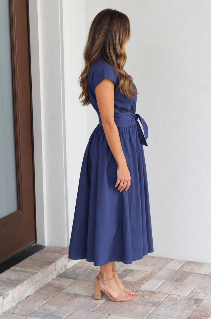 side view of mom wearing a blue cotton nursing dress