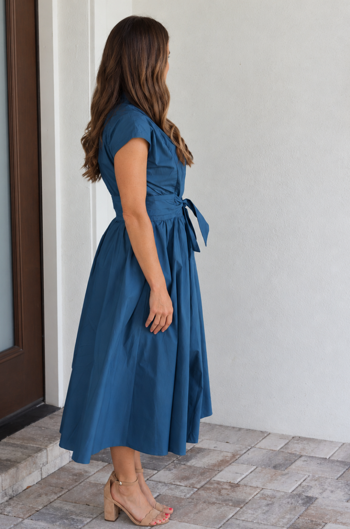 Side view of a cotton poplin nursing dress in peacock bl