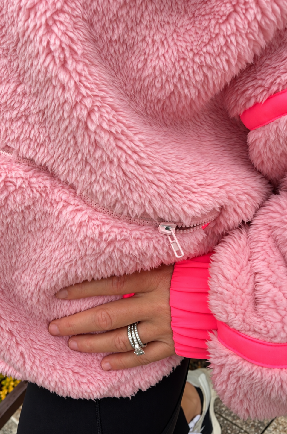 Close up view of a mom in a pink nursing fleece jacket 