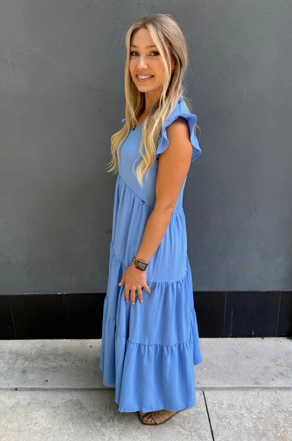 Blue breastfeeding dress with tiered midi length, flutter ruffle sleeves, and concealed nursing access for comfortable postpartum wear