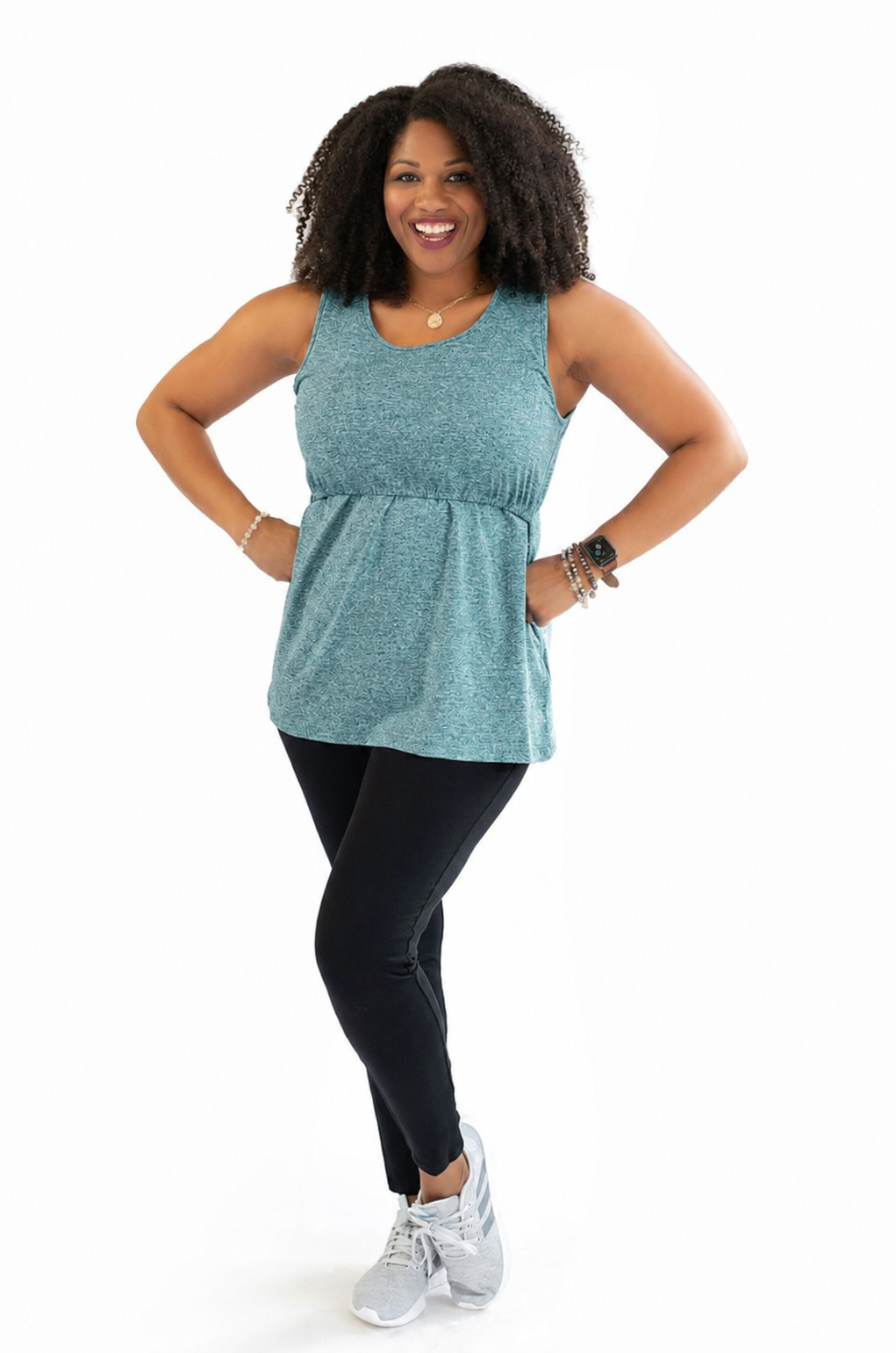 Active mom wearing a teal breastfeeding workout tank designed with hidden breastfeeding access and performance fabric to help keep moms cool, comfortable, and ready for movement.