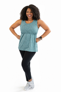 Active mom wearing a teal breastfeeding workout tank designed with hidden breastfeeding access and performance fabric to help keep moms cool, comfortable, and ready for movement.
