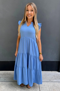 Breastfeeding mom wearing blue tiered nursing midi dress with ruffle sleeves and hidden zipper access for easy nursing and pumping