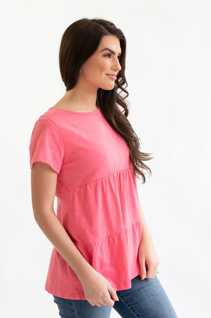 Side view of a mom wearing the ruffle nursing tee in watermelon color.