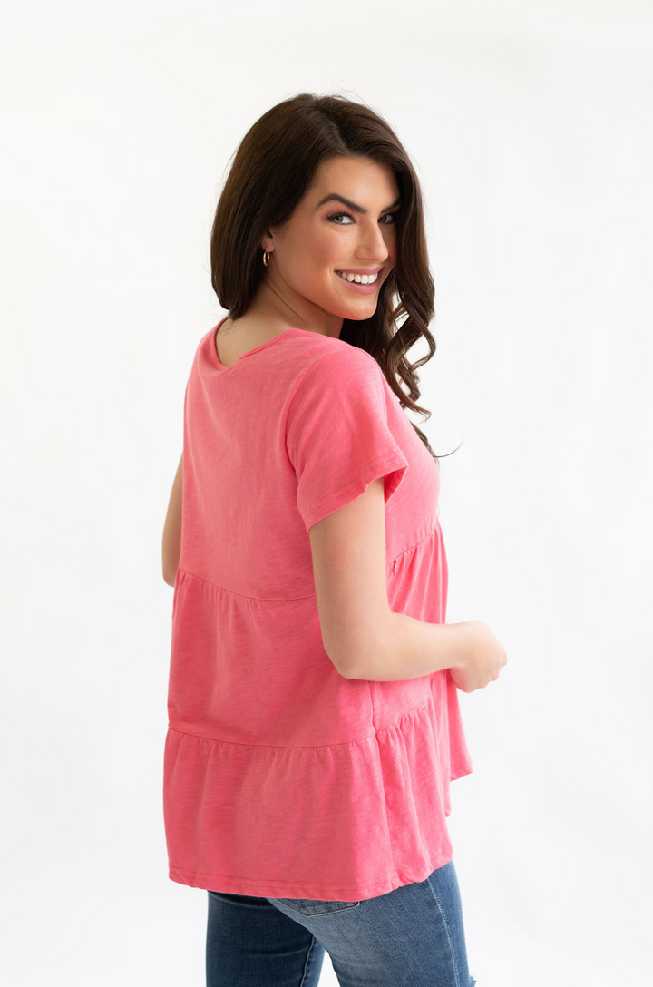 Back view of a mom wearing a nursing and pumping ruffle tee with hidden access. 