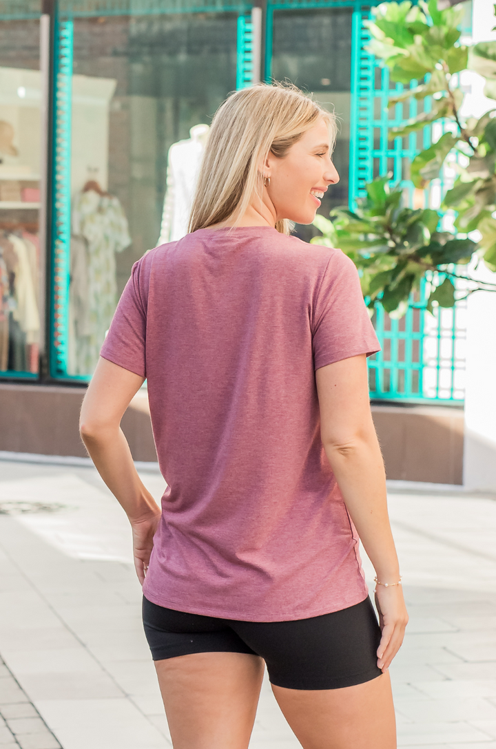 Back view of a mom wearing a heather plum breastfeeding shirt. 