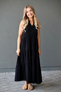 Woman wearing a black, cotton sleeveless nursing dress with hidden access for breastfeeding. 