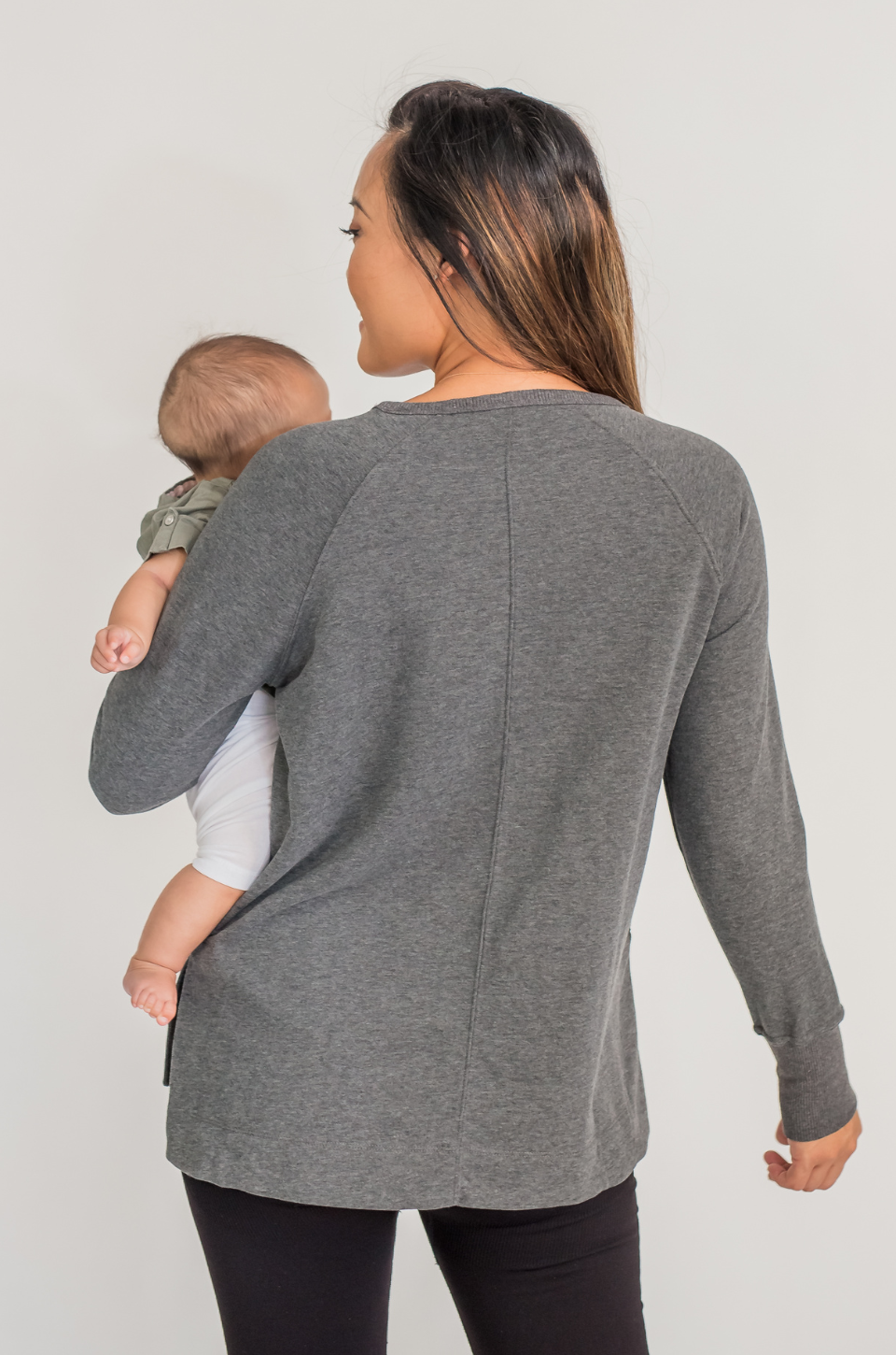Mom with dark gray nursing tunic for breastfeeding on the go