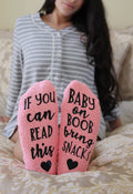 model wearing baby on boob fuzzy socks