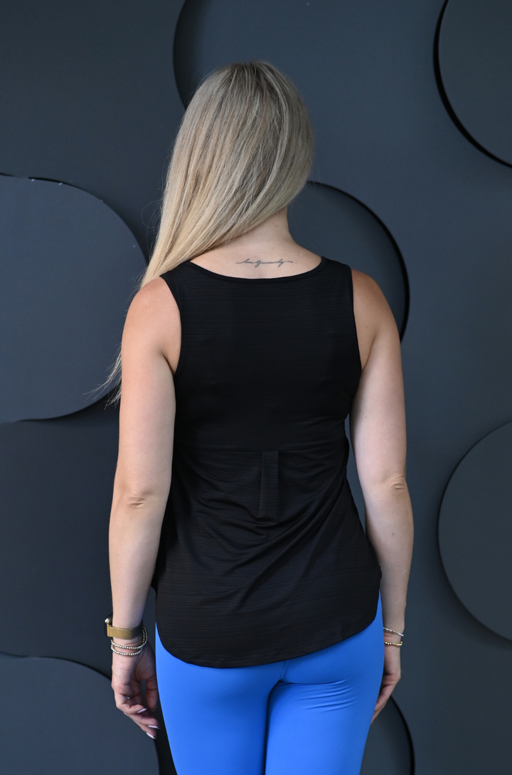 Back view of a black breastfeeding workout tank featuring lightweight performance fabric and an athletic fit, designed to provide comfort for workouts, walks, travel, and everyday wear while breastfeeding.