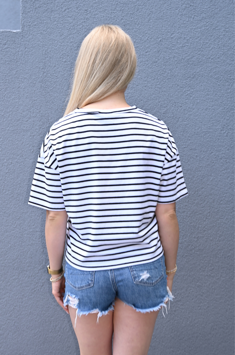 Back view of relaxed fit striped breastfeeding shirt with hidden nursing access, lightweight black and white nursing tee designed for breastfeeding.