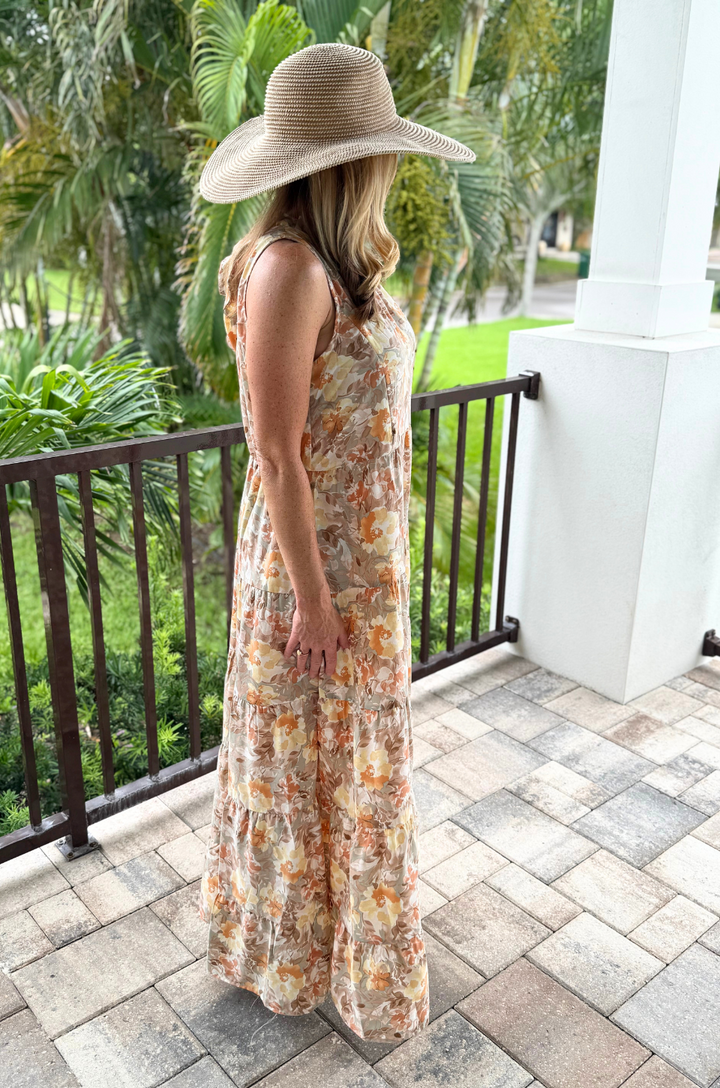 A side view shows a mom wearing the floral sunset tie-back nursing dress, highlighting how the fabric drapes softly and moves with her.