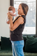 Mom holding baby wearing a ruffle tee for nursing
