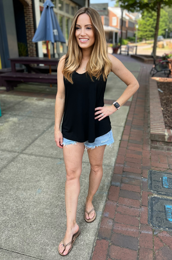 Front view of black nursing swing tank top with flowy silhouette and side opening breastfeeding access.