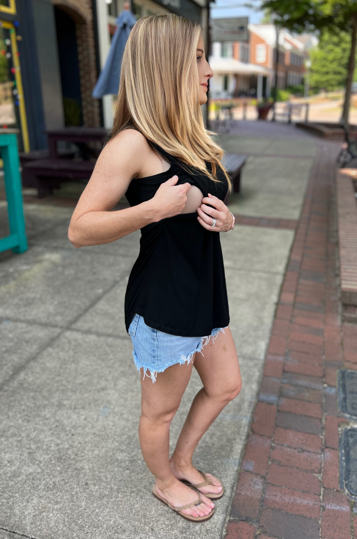 Close-up of side opening on black nursing swing tank top revealing breastfeeding access.