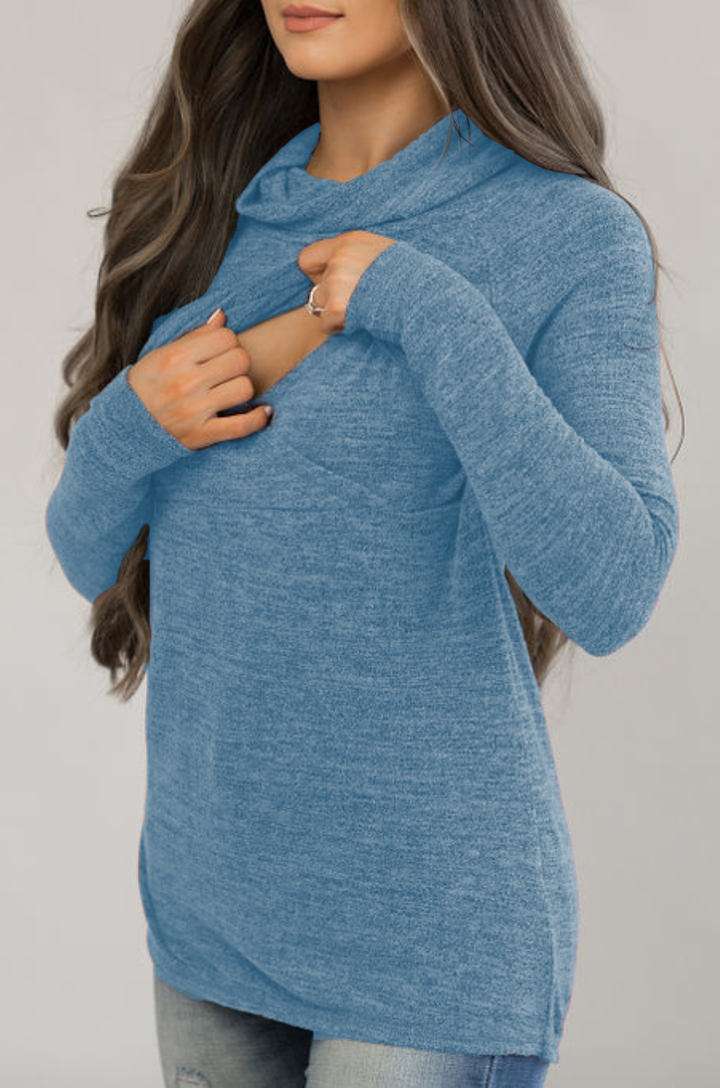 Close-up of asymmetrical front flap on blue breastfeeding sweater revealing inner layer for nursing and pumping access.
