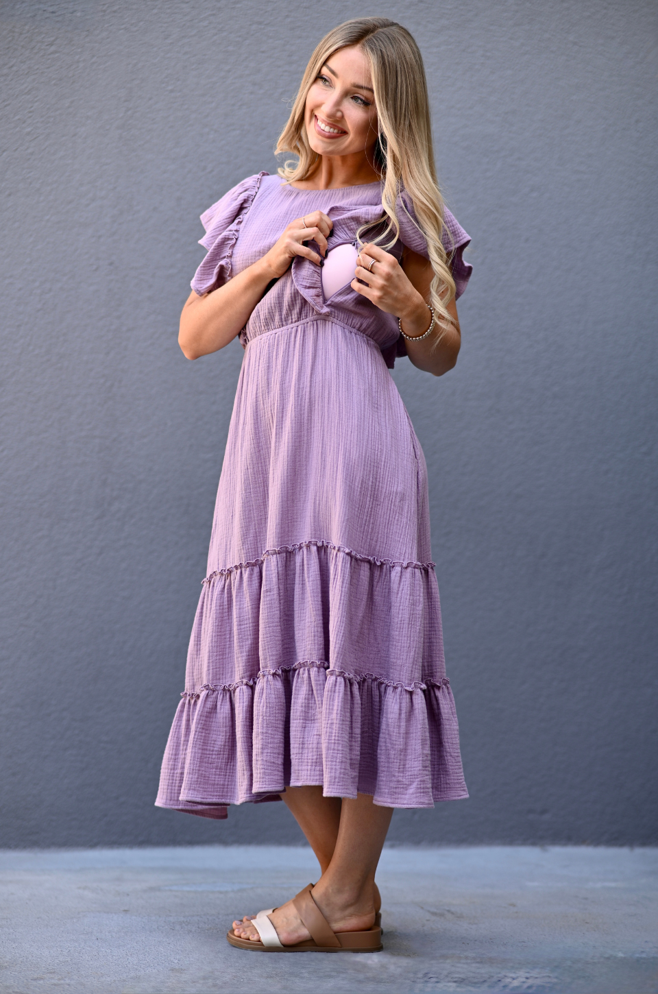 Close view of hidden zipper nursing access behind ruffles on lavender gauze midi dress designed for breastfeeding.