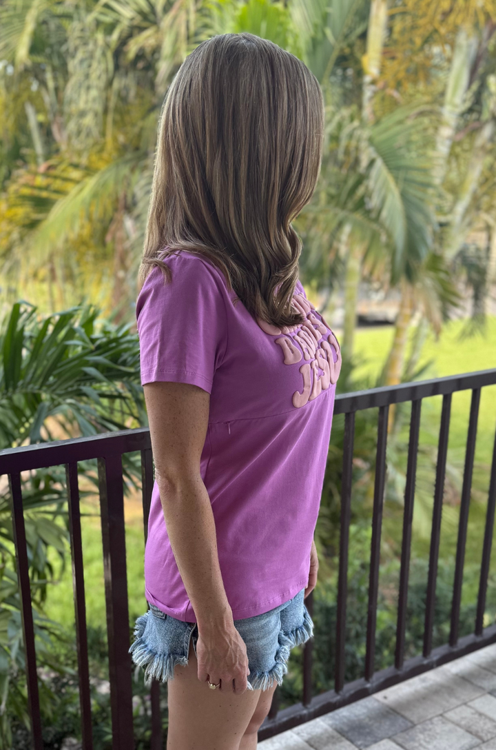 Side view of a mom wearing a purple breastfeeding T-shirt, showing relaxed fit and short sleeves
