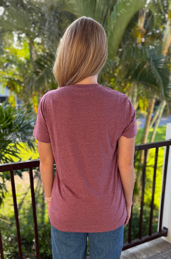 Back view of heather plum breastfeeding T-shirt worn by a breastfeeding mom, showing plain back design
