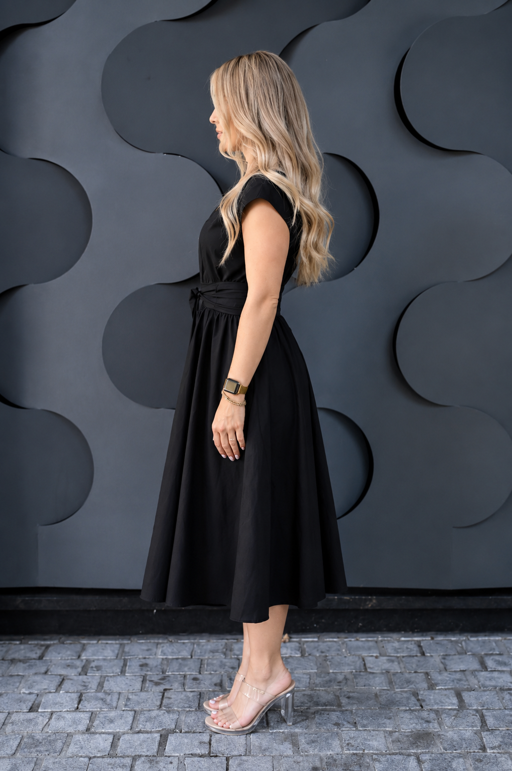 a woman showing a formal cotton nursing dress from the side