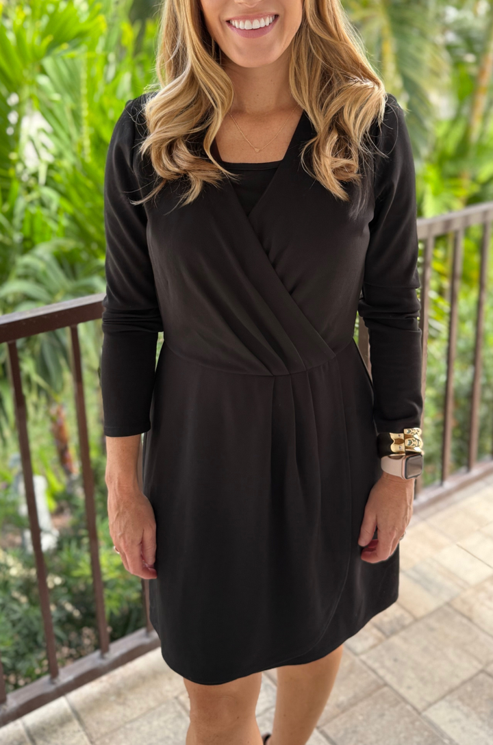 Close-up of the front design on the black ponte knit faux wrap nursing dress, showing the overlapping wrap-style panels and smooth fabric texture