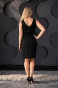 a woman wearing a black formal nursing dress back view of the dress