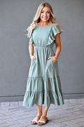 Woman wearing a seafoam green gauze midi nursing dress with hidden zipper breastfeeding access and pockets by Nursing Queen.