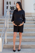 Pregnant model wearing this black maternity and nursing dress, showing a comfortable and flattering maternity fit.