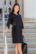 Model wearing the Nursing Queen black maternity and nursing dress with discreet gold zipper access.
