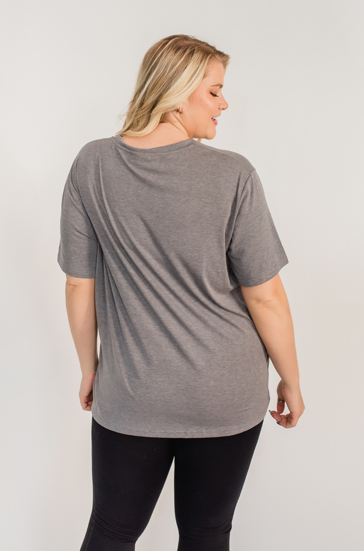 A back view shows a mom wearing the Nashville nursing graphic gray t-shirt paired with leggings, offering full coverage and a relaxed silhouette.