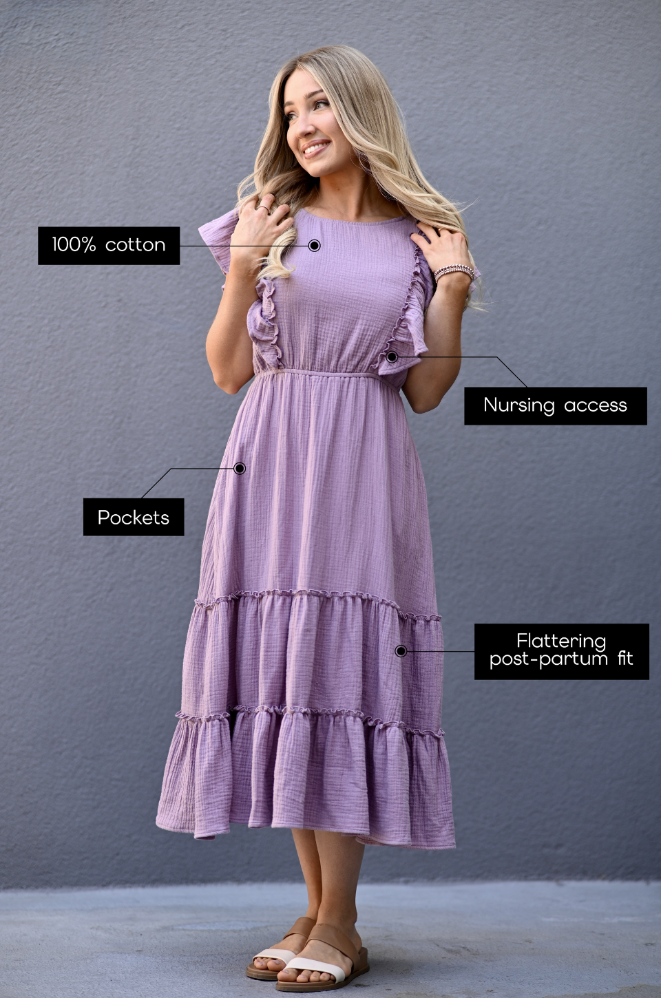 Woman wearing a lavender gauze midi nursing dress made from 100% cotton with hidden zipper nursing access, pockets, and flattering postpartum fit.