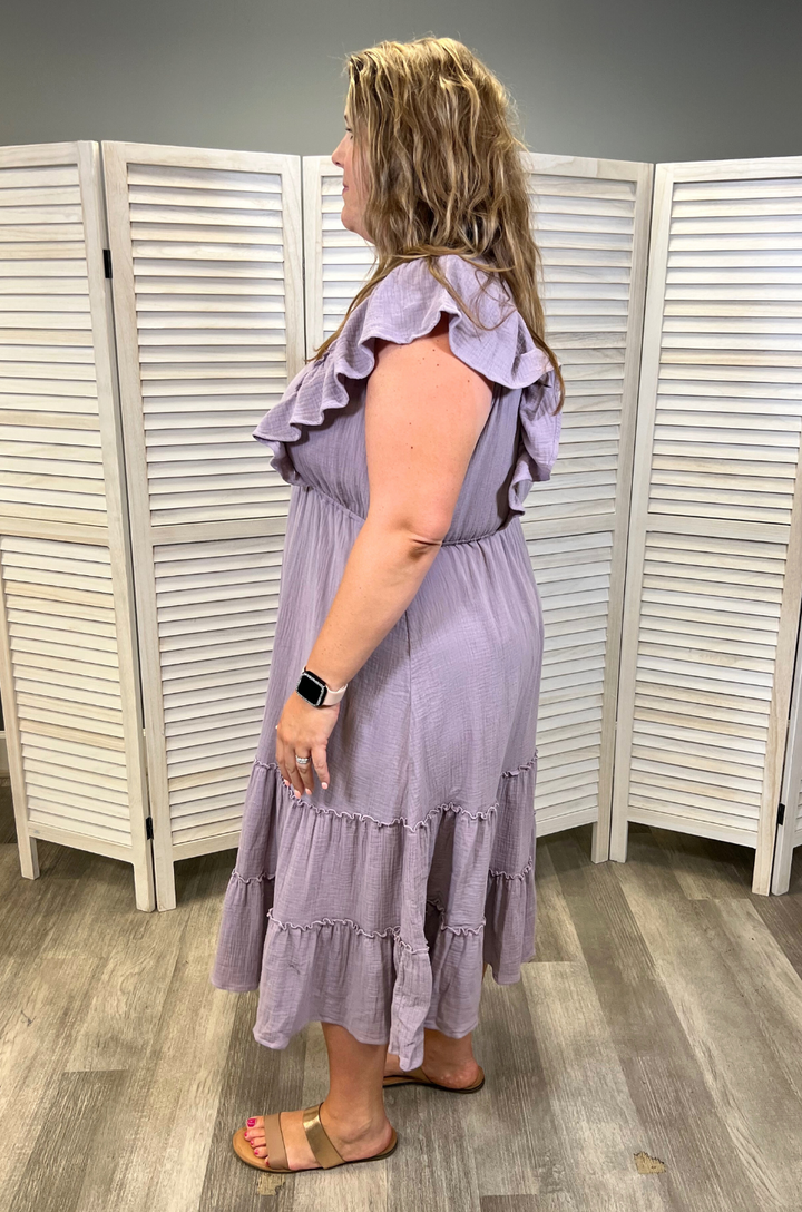 A side view shows a mom wearing the lavender gauze ruffle midi breastfeeding dress made from soft cotton, highlighting its comfortable drape and flowy silhouette.