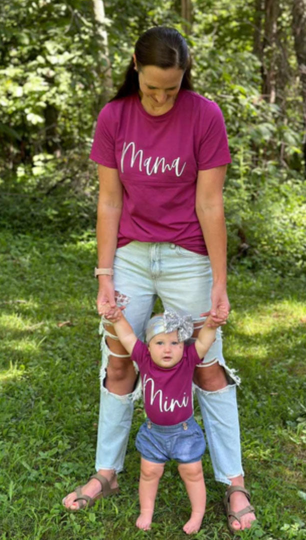 mom and baby wearing matching berry “Mama” and “mini” t-shirts