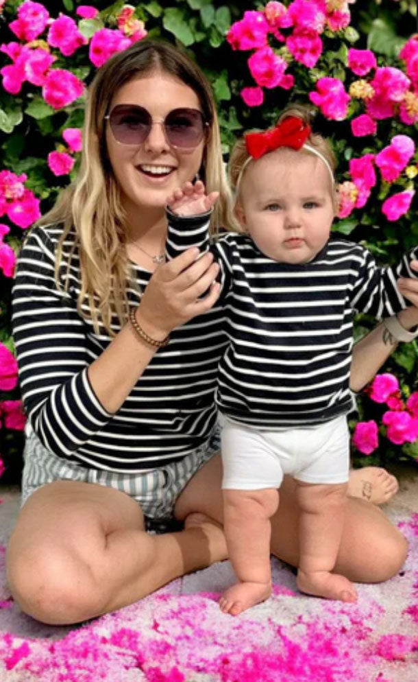mom and baby wearing matching navy and white shirts
