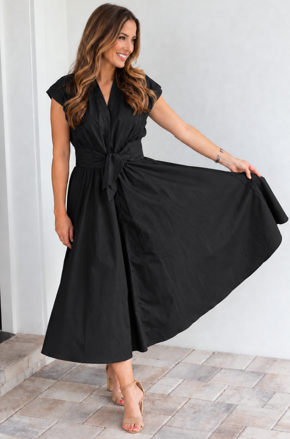 Mom wearing a black nursing dress with hidden access for breastfeeding