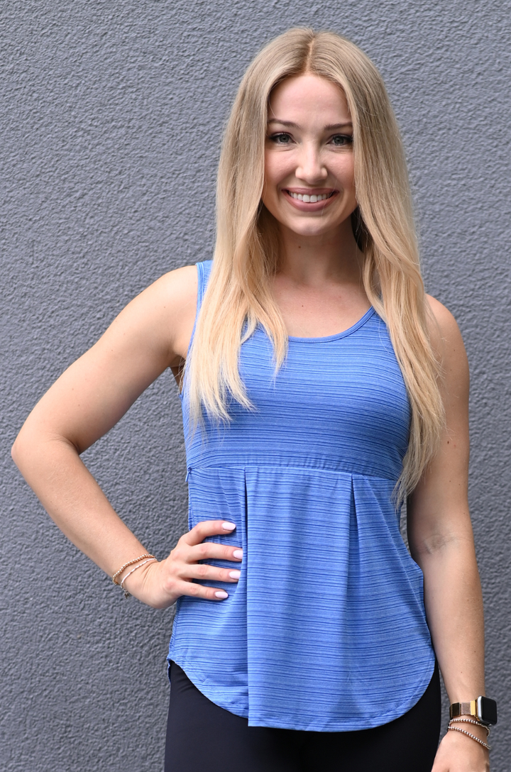Mom wearing blue workout tank for breastfeeding with hidden zipper access for nursing and pumping
