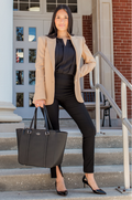 Mom in professional breastfeeding clothes holding a black tote bag on steps outside a building