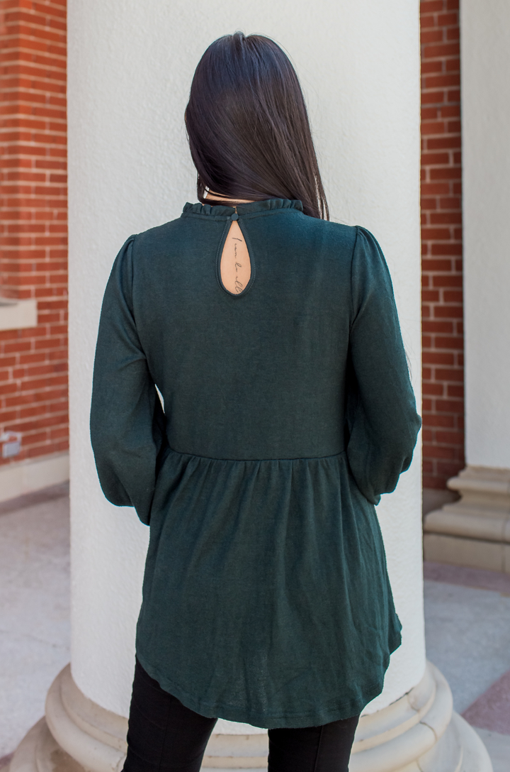 Back view of the babydoll nursing sweater in deep green, showing full coverage and a flattering babydoll silhouette.