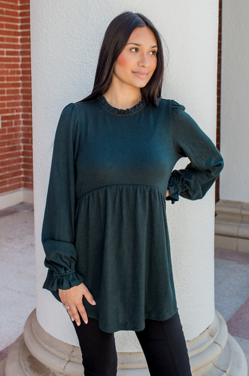 Model wearing the Nursing Queen babydoll nursing sweater in deep green with a relaxed fit.