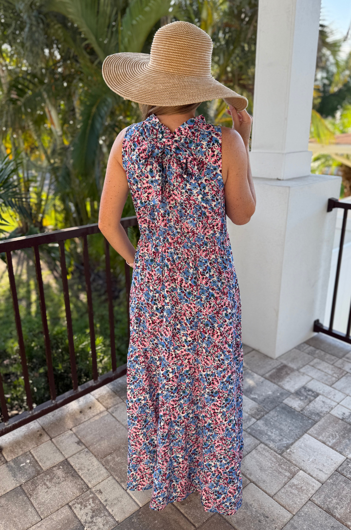 The back view shows a mom in the berry garden tie-back bow breastfeeding dress and the tied bow detail that accents the waist.