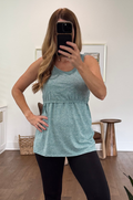 woman wearing workout breastfeeding activewear top for nursing mom in teal color