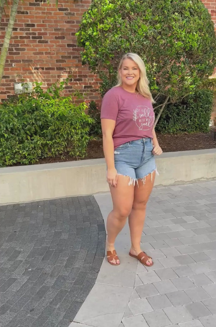 Video of a breastfeeding mom wearing a heather plum breastfeeding T-shirt, showing fit, movement, and everyday styling.