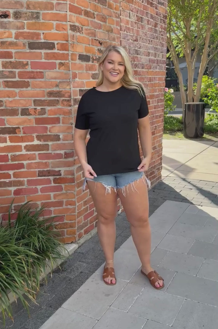 Video showing a breastfeeding mom wearing a black cotton nursing shirt and demonstrating the hidden zipper access.