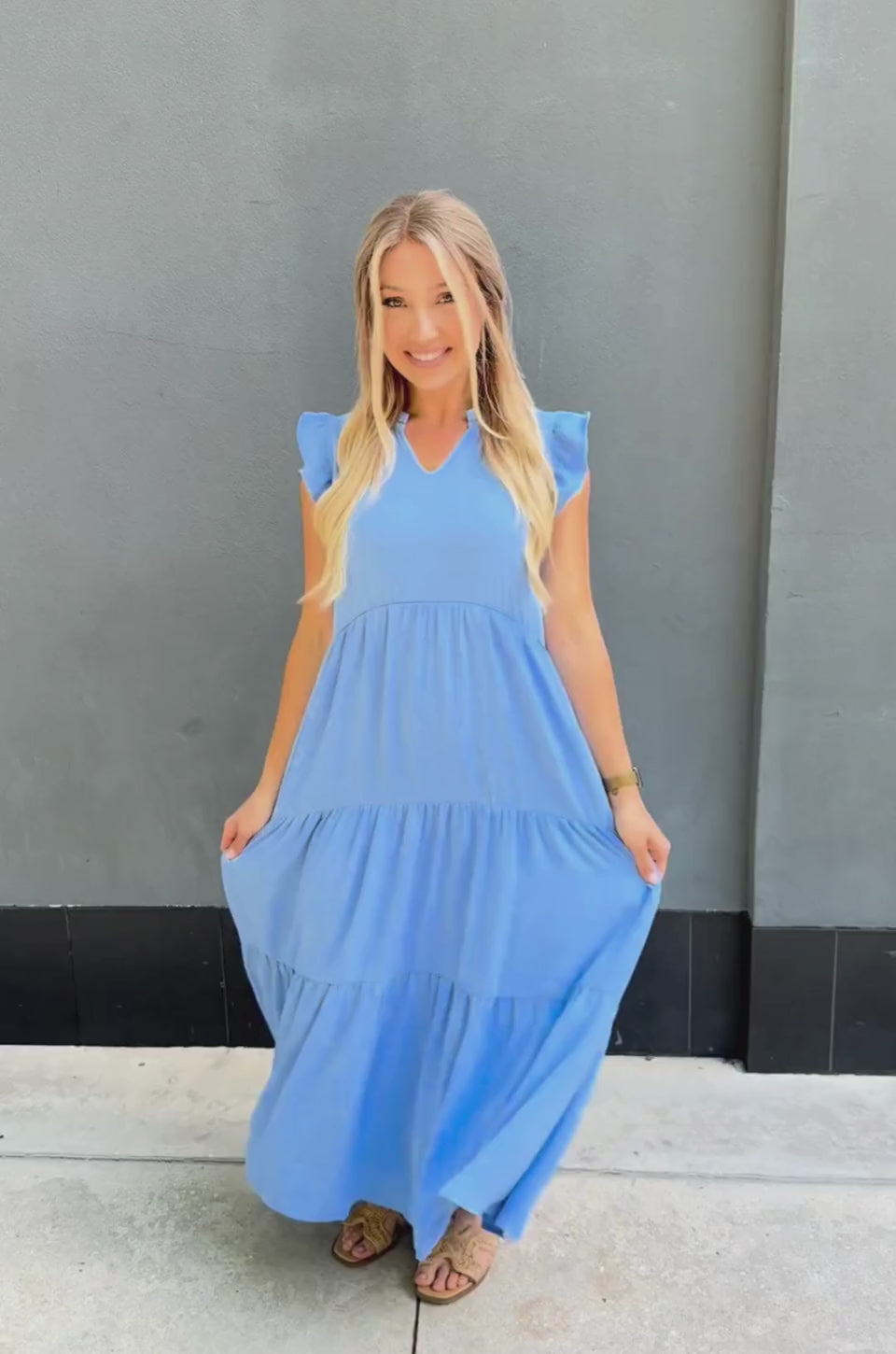 Woman trying on blue tiered nursing midi dress with ruffle sleeves, showing hidden zipper access for breastfeeding and a flattering postpartum fit