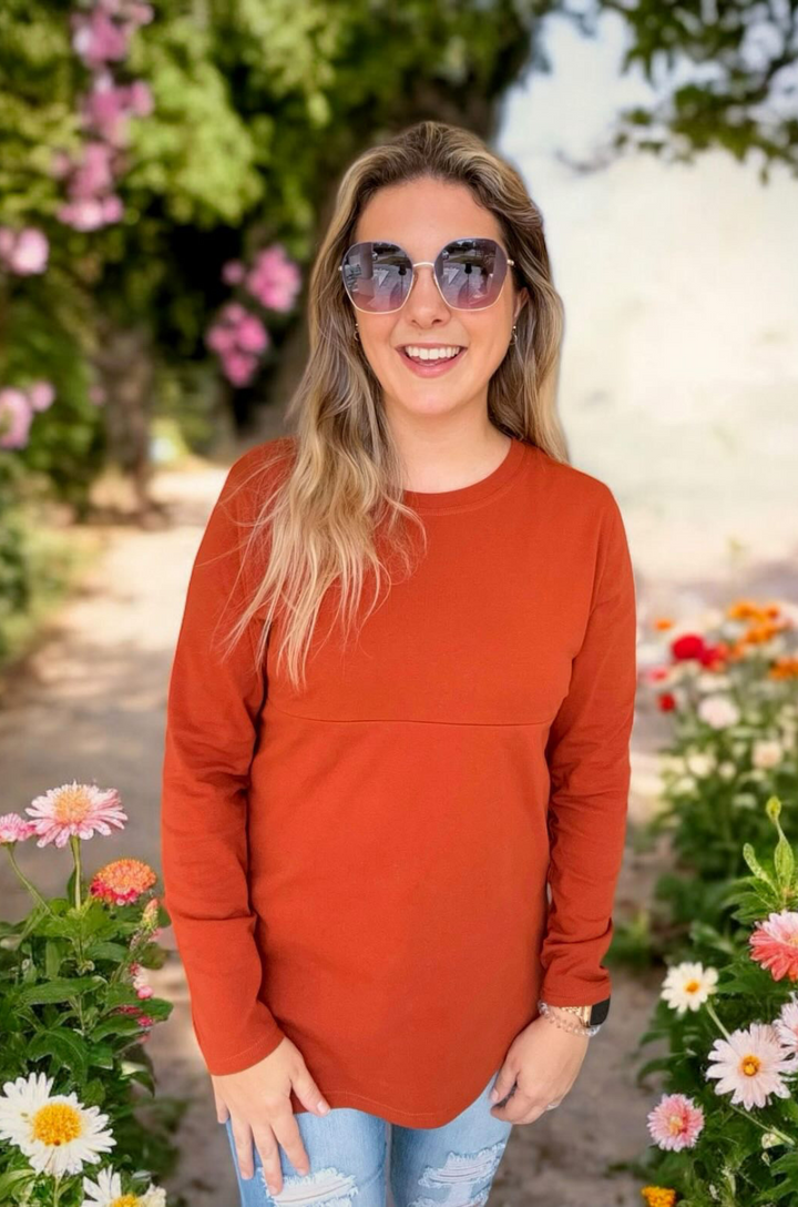Front view of rust long sleeve breastfeeding tunic top with relaxed fit and concealed zipper breastfeeding access.
