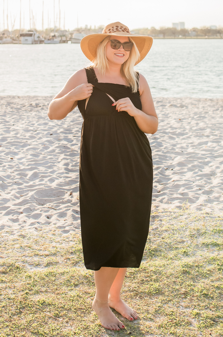 Close-up of nursing access detail on smocked black maxi dress. 