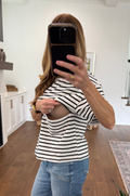 woman showing the hidden zipper nursing access for breastfeeding in black and white striped tee