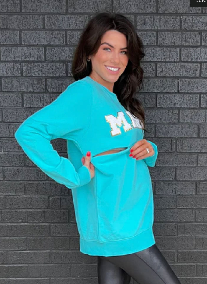 model wearing a teal “MAMA” nursing sweatshirt
