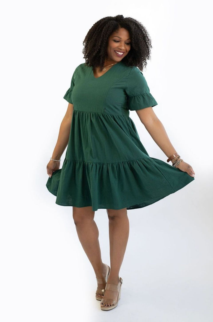 The green bell sleeve nursing dress with pockets is shown from the front highlighting its flattering fit for breastfeeding moms.