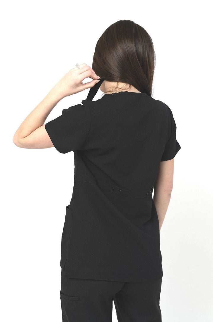 Back view of black breastfeeding scrub top worn by mom.